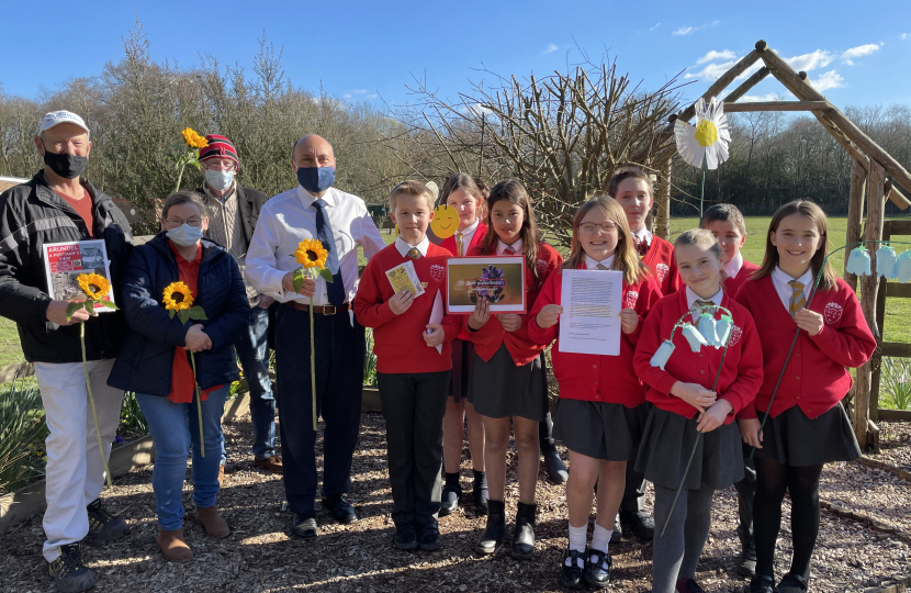 Andrew pictured with pupils of Arundel CofE Primary School before scattering their wildflower seeds.