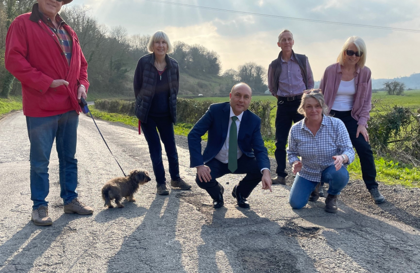 Andrew with residents on Burpham Road, inspecting the road erosion.