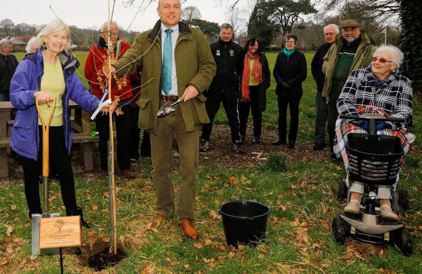 Andrew Griffith planting tree in Slindon with Parish Council Chair Jan Rees