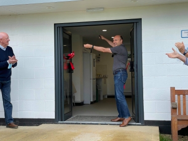 Andrew cutting the ribbon to the new Southdown Gliding Club classroom extension.