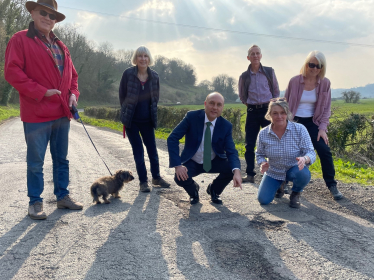 Andrew with residents on Burpham Road, inspecting the road erosion.