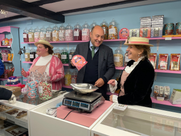 Andrew behind the sweet shop counter 