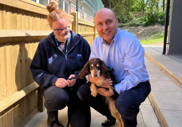 Andrew holding a puppy spaniel at the RSPCA