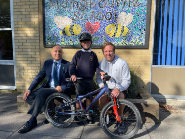 Andrew with young cyclist Rowan and teacher Mr Trent at Aldingbourne Primary School