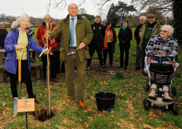 Andrew Griffith planting tree in Slindon with Parish Council Chair Jan Rees